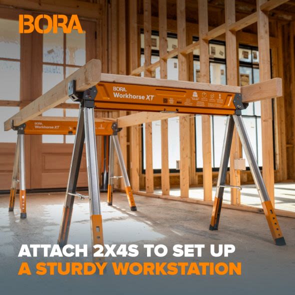 Sturdy metal workstation frame with orange and silver finish supporting wooden 2x4s for home improvement projects