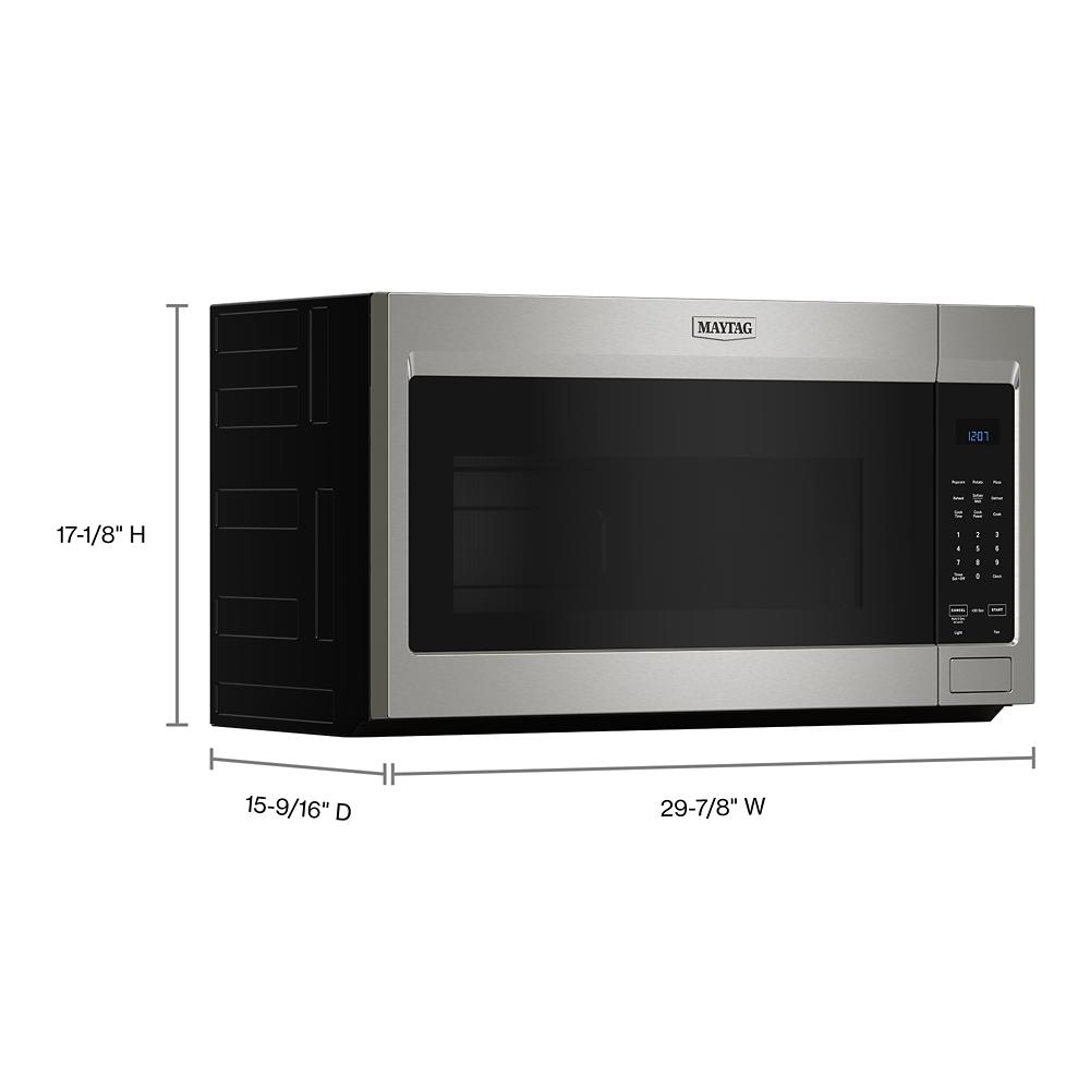 Stainless steel over-the-range microwave with digital control panel and black tinted glass door in kitchen appliance setting