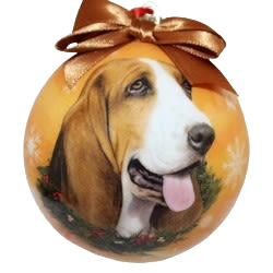 Round Christmas ornament featuring a detailed Basset Hound portrait with festive greenery and metallic bow on top