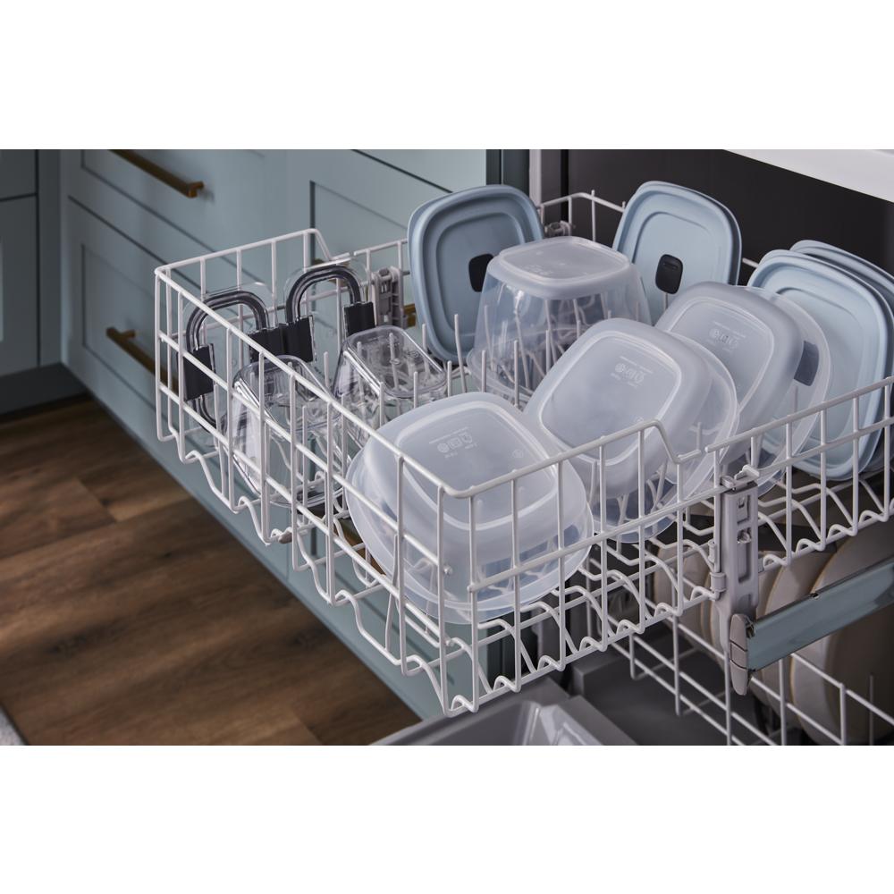 Upper dishwasher rack filled with plastic food storage containers and lids for kitchen and home improvement use