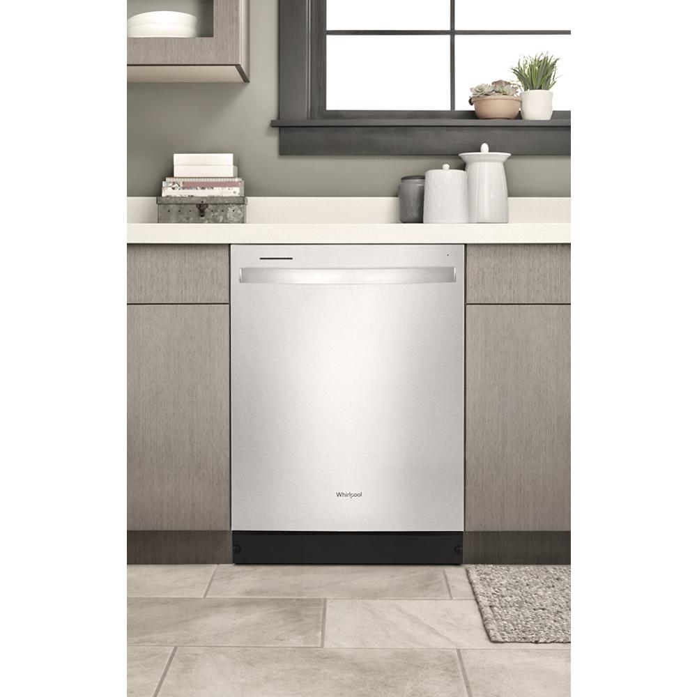 Built-in stainless steel dishwasher installed under countertop with modern cabinetry in kitchen and kitchenware appliances collection