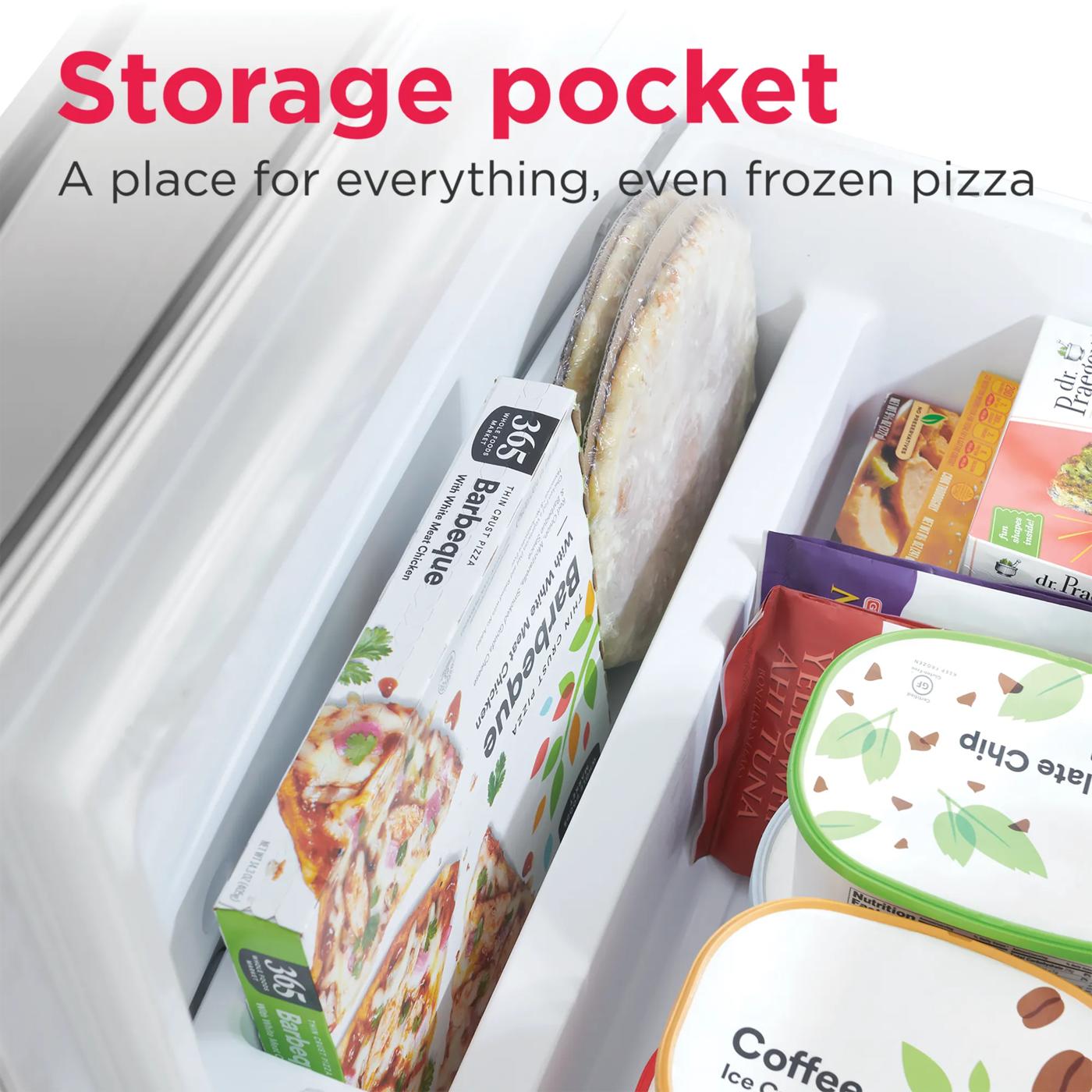 Close-up of storage pocket inside bottom freezer drawer organizing frozen pizzas and packaged foods