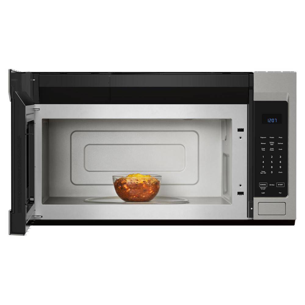 Over the range microwave with digital control panel and open door showing bowl of food inside in kitchen setting