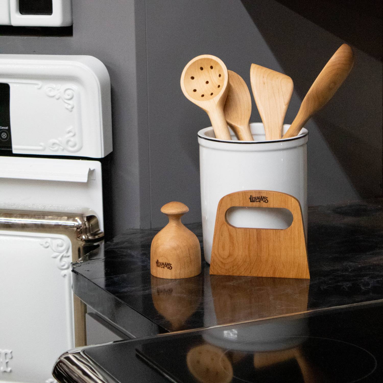 Handcrafted solid American Hard Maple wooden spoons, spatula, and scraper in white crock on kitchen counter under $50