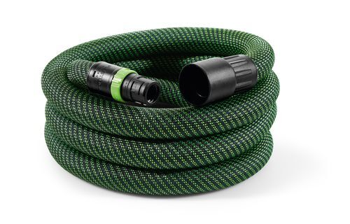 Coiled green braided hose with black connectors designed for use with cordless mobile dust extractors in home improvement tasks