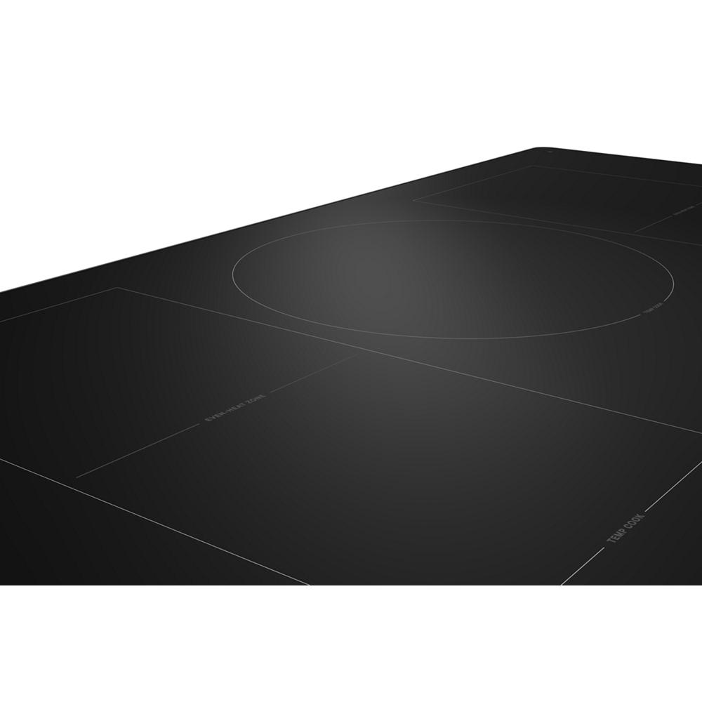 Sleek black induction cooktop with five cooking zones in modern KitchenAid appliances and kitchenware collection