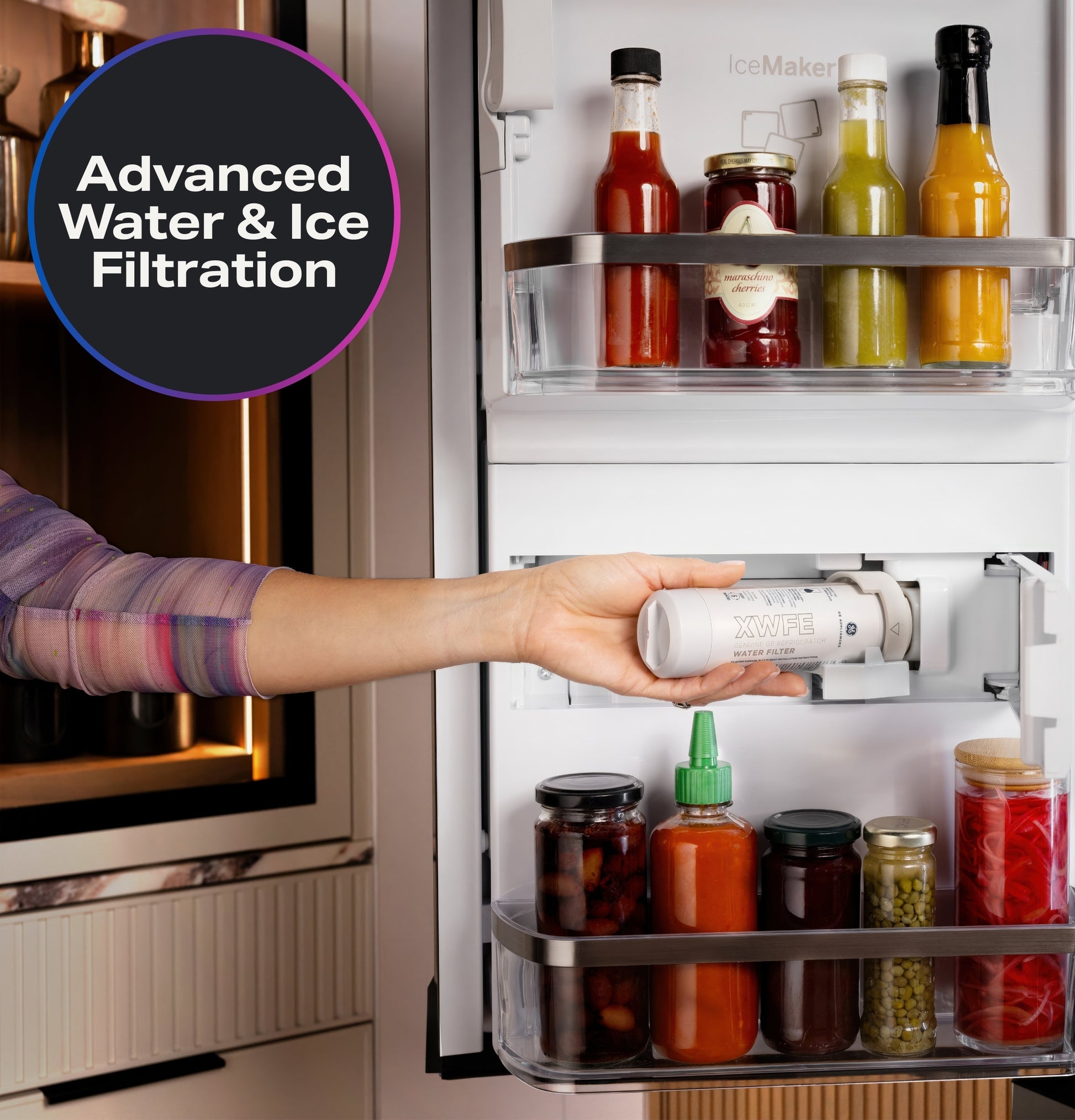 Hand installing advanced water and ice filtration system inside door of stainless steel French-door refrigerator