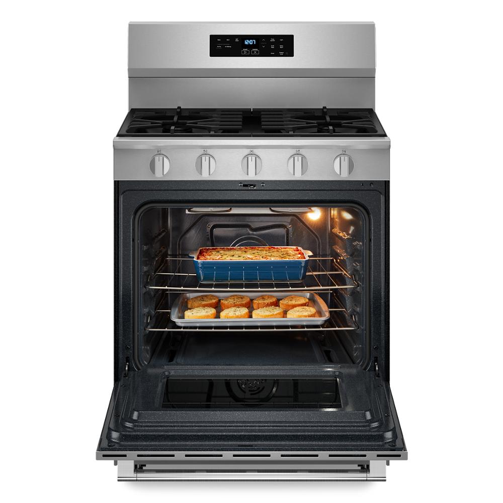 30-inch stainless steel gas range in kitchen appliances with open oven door and baked dishes inside