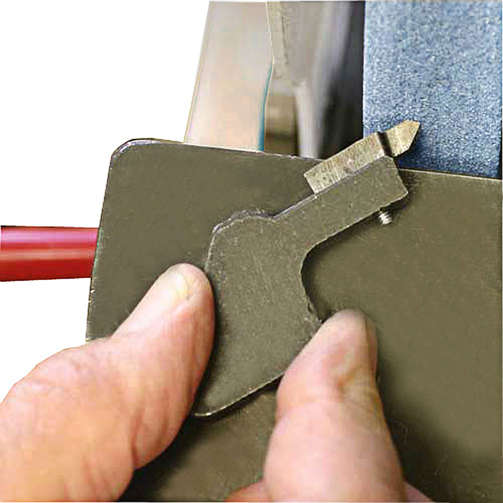 Hand holding an Easy-Core cutter sharpening jig blade against a grinding wheel for precise sharpening in woodworking tools collection