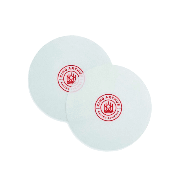Two reusable nonstick round silicone pan liners with red logo for kitchenware and bakeware use under $50 collections
