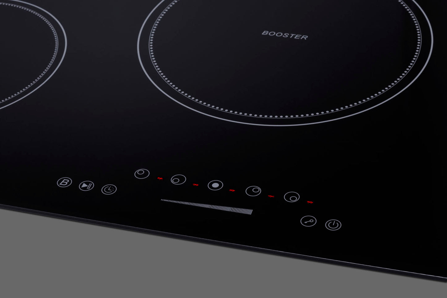 Black glass cooktop with five induction zones and touch controls for modern kitchen appliances collection