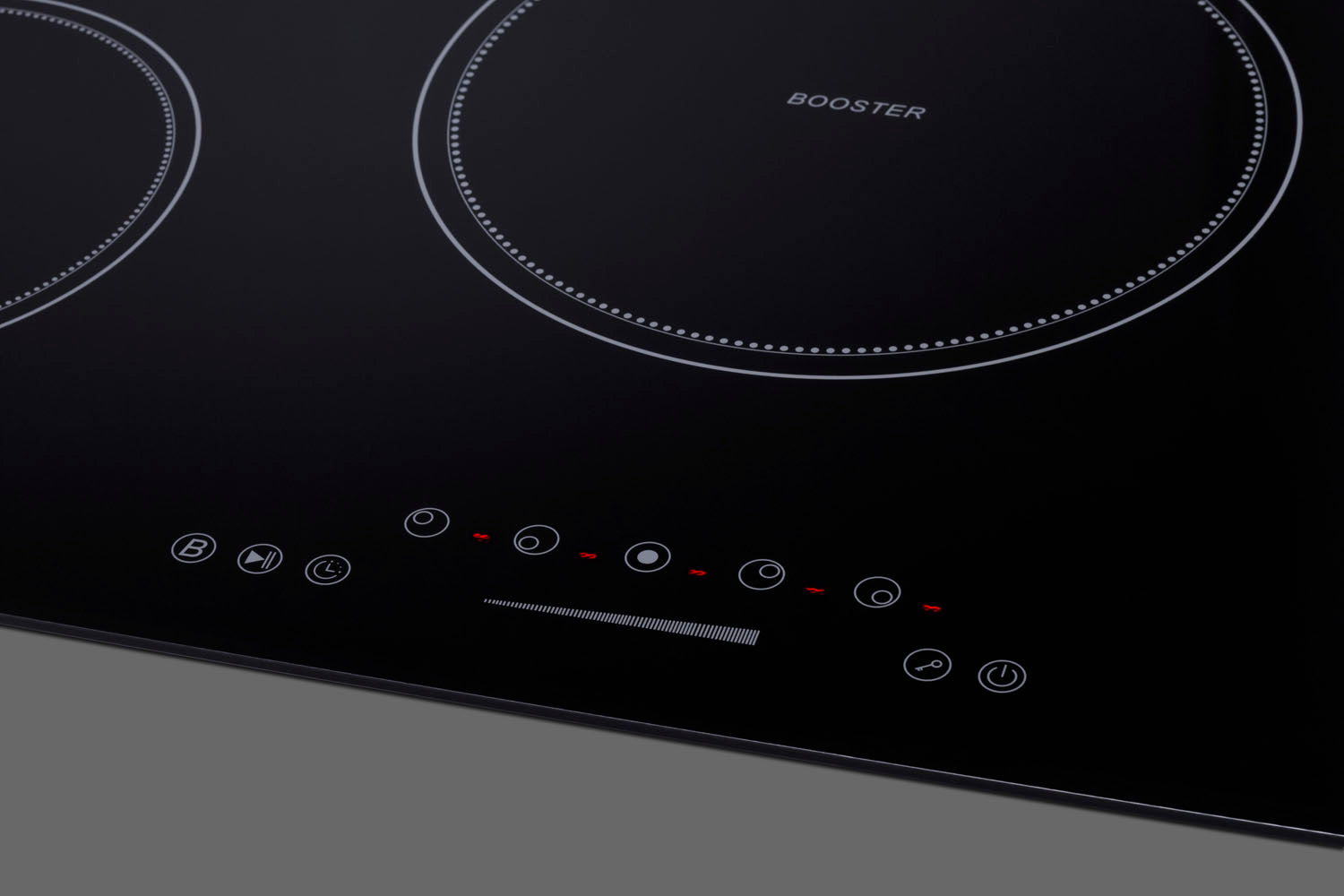 Black glass cooktop with five induction zones and touch controls for modern kitchen appliances collection