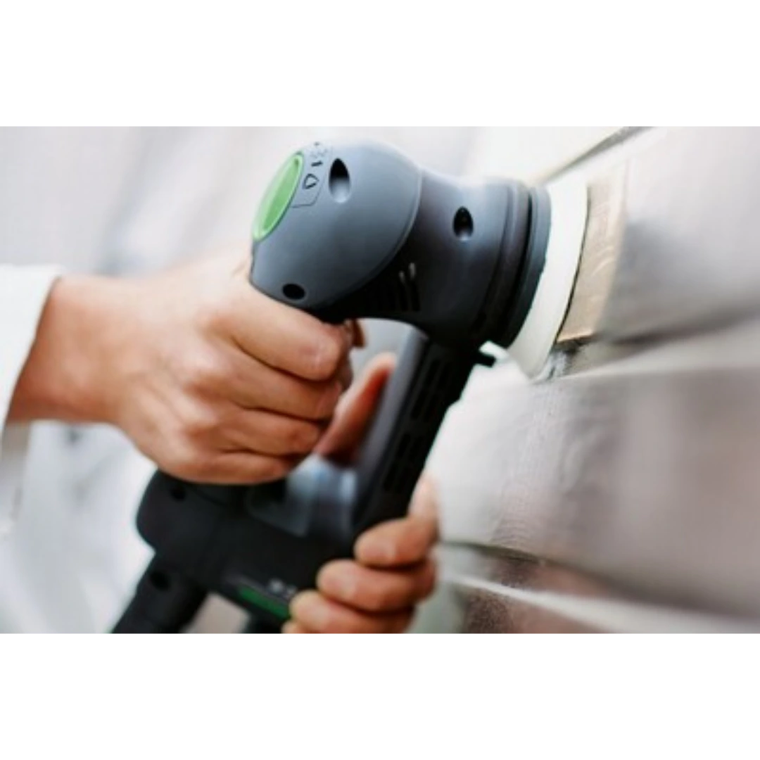 Person using a handheld power sander with a soft sanding pad on a wooden surface in woodworking tool accessories