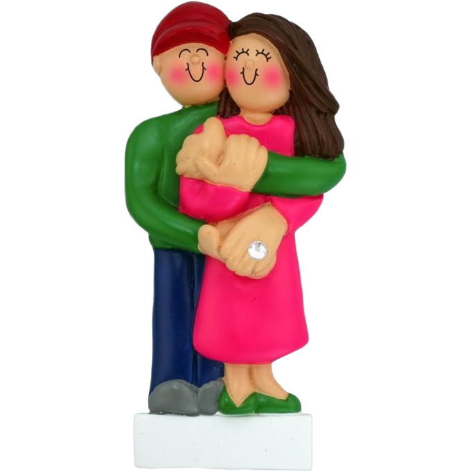 Handcrafted figurine of brunette woman in pink dress and man in green shirt embracing with engagement ring in Christmas collection under $50