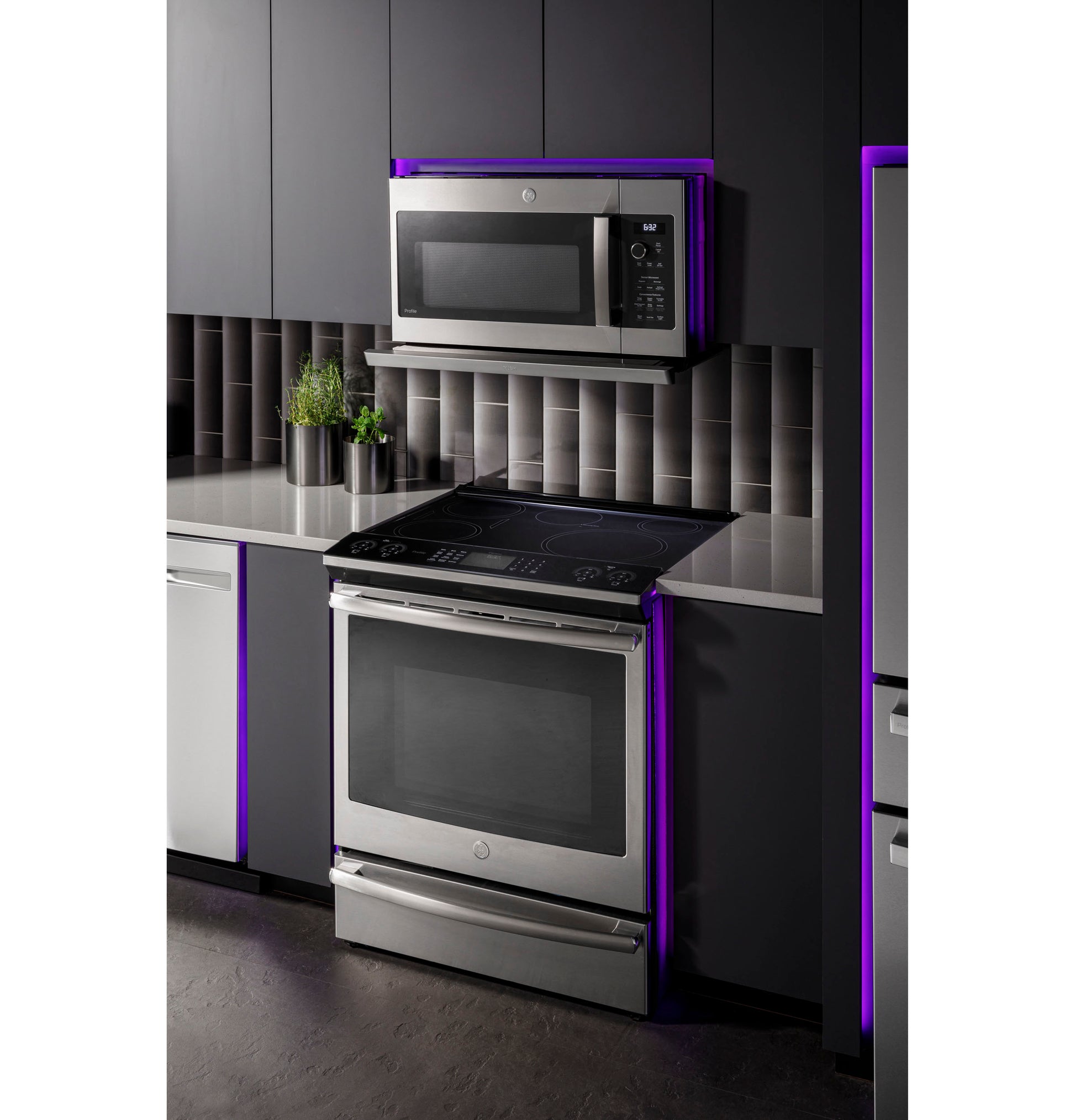 Stainless steel over-the-range microwave with control panel above modern electric oven in kitchen appliances collection
