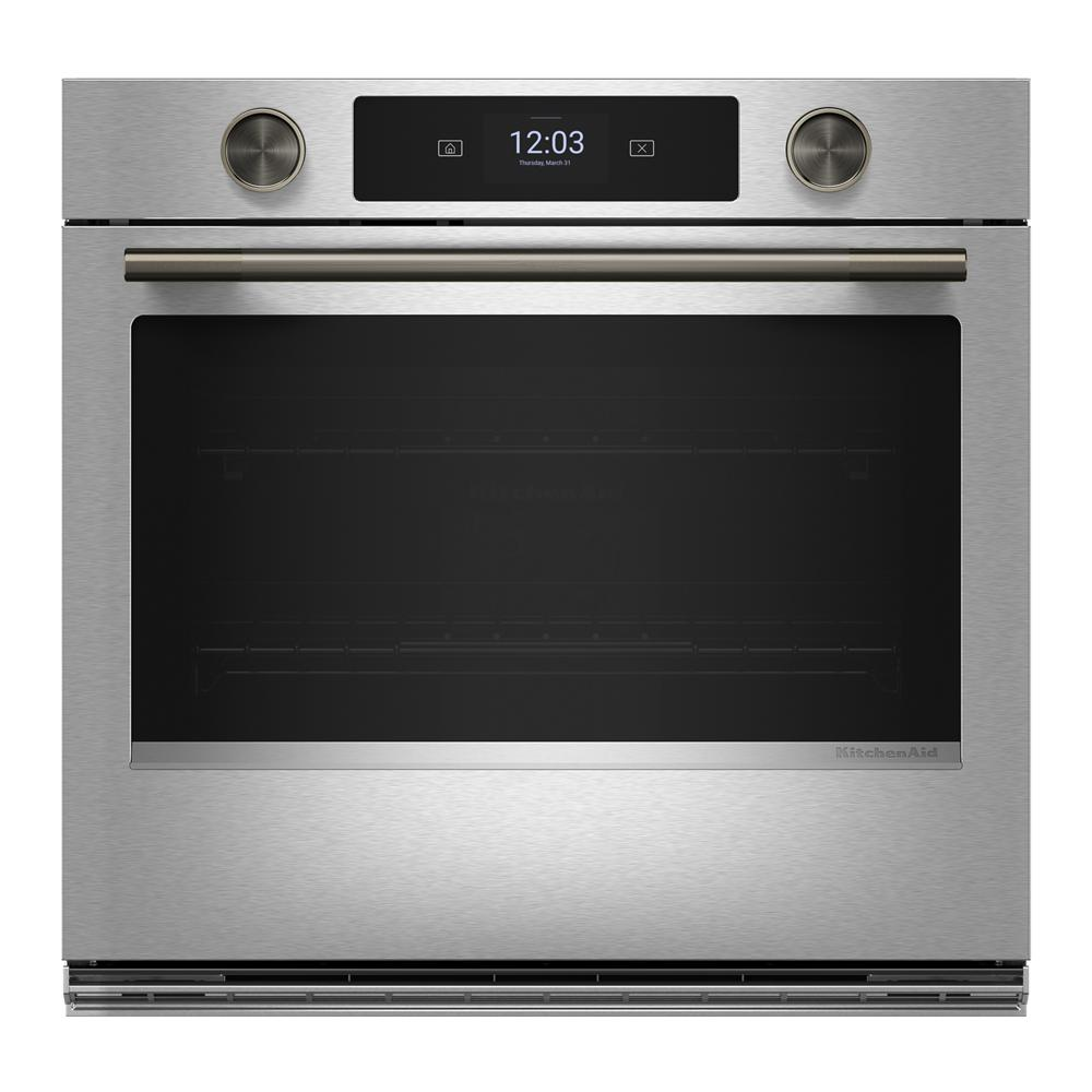 Stainless steel smart electric single wall oven with LED display, backlit knobs, and brushed metal handle in modern kitchenware setting