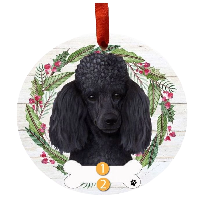 Round Christmas ornament with a black poodle face surrounded by festive greenery and red berries wreath and red ribbon