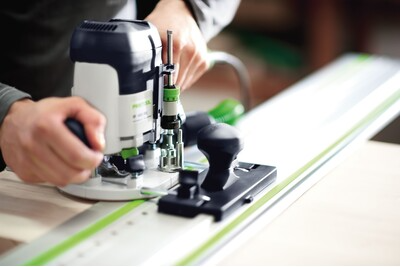 Person using a Festool guide rail with a router for precise woodworking in power tool and woodshop accessories collections
