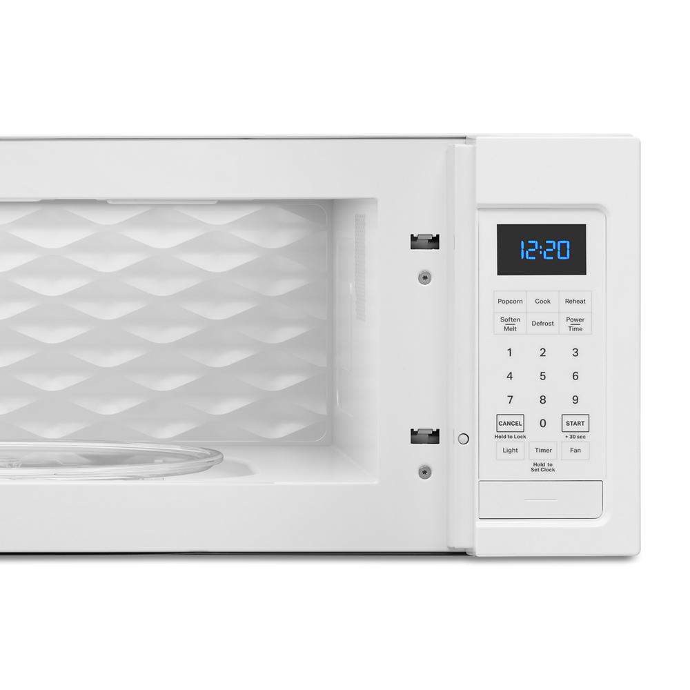 white low profile microwave interior with textured back wall and digital control panel for kitchen appliances