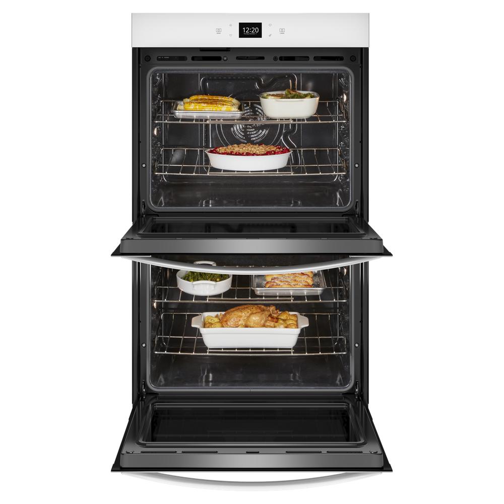 Open double wall oven with cooked poultry and casseroles inside from kitchen appliances collection