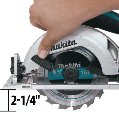 Hand adjusting blade depth on teal and silver cordless circular saw for home improvement tasks