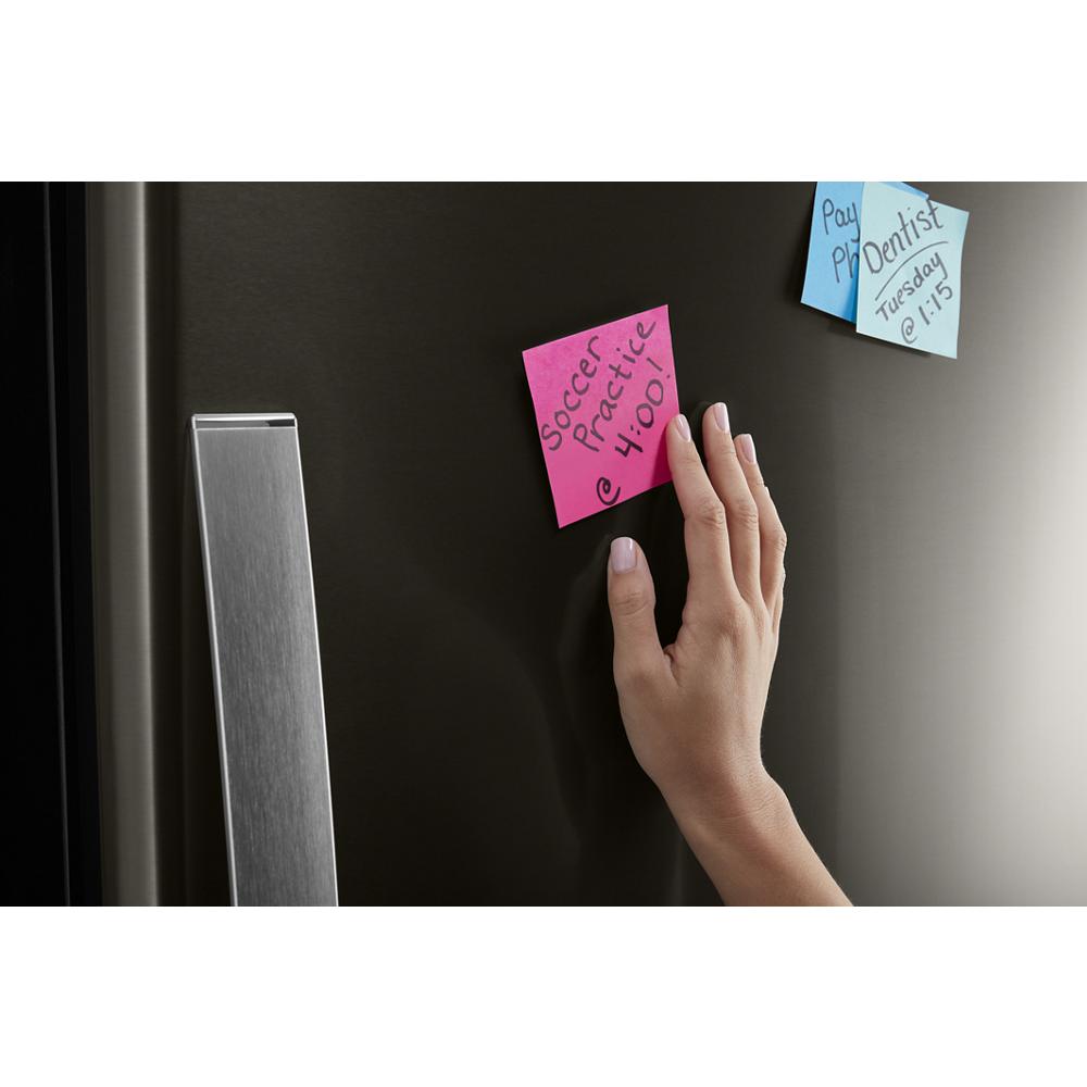 Matte black bottom-freezer refrigerator door with stainless steel handle and colorful sticky notes from Appliances collection