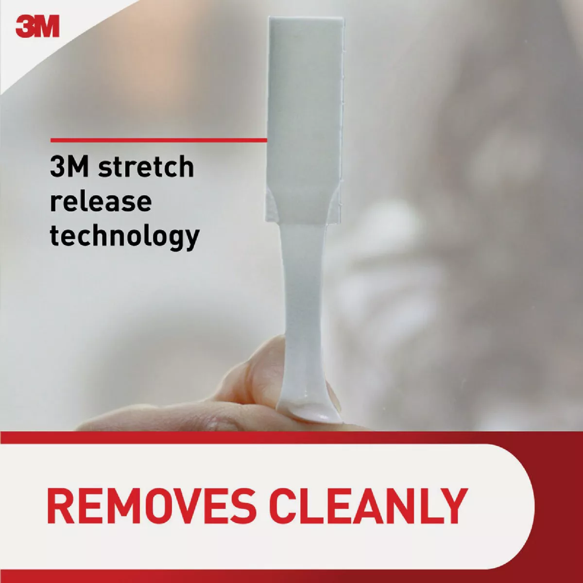 Hand holding a 3M stretch release strip demonstrating damage-free removal in Hardware and Fasteners collections under $50