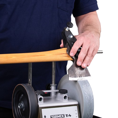 Man sharpening an axe blade with a precision grinding tool for home improvement and outdoor tool maintenance