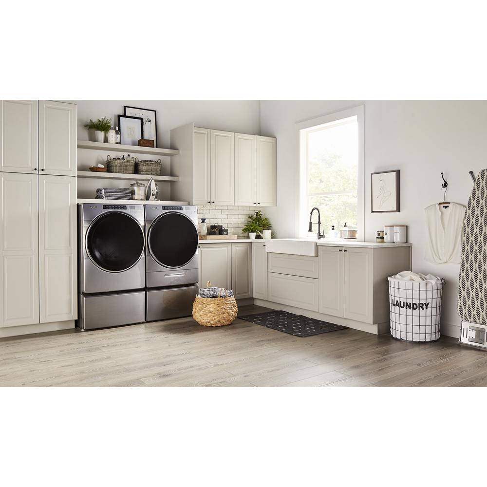 Modern laundry room with silver front load washer and dryer on storage pedestals in Appliance Parts & Accessories collection