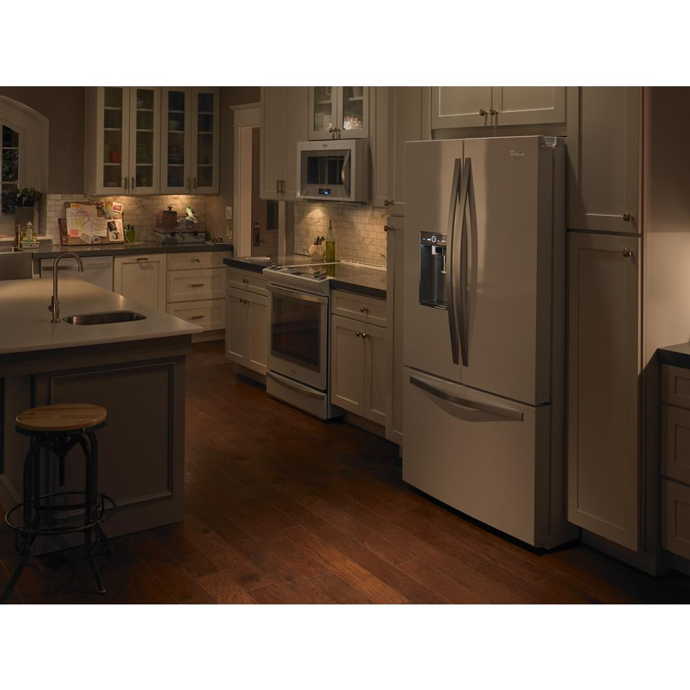 Spacious modern kitchen with stainless steel appliances, hardwood floors, and under-cabinet lighting from kitchenware collections
