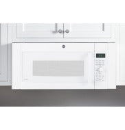 White over-the-range microwave accessory filler kit installed in a modern kitchen setting with white cabinetry