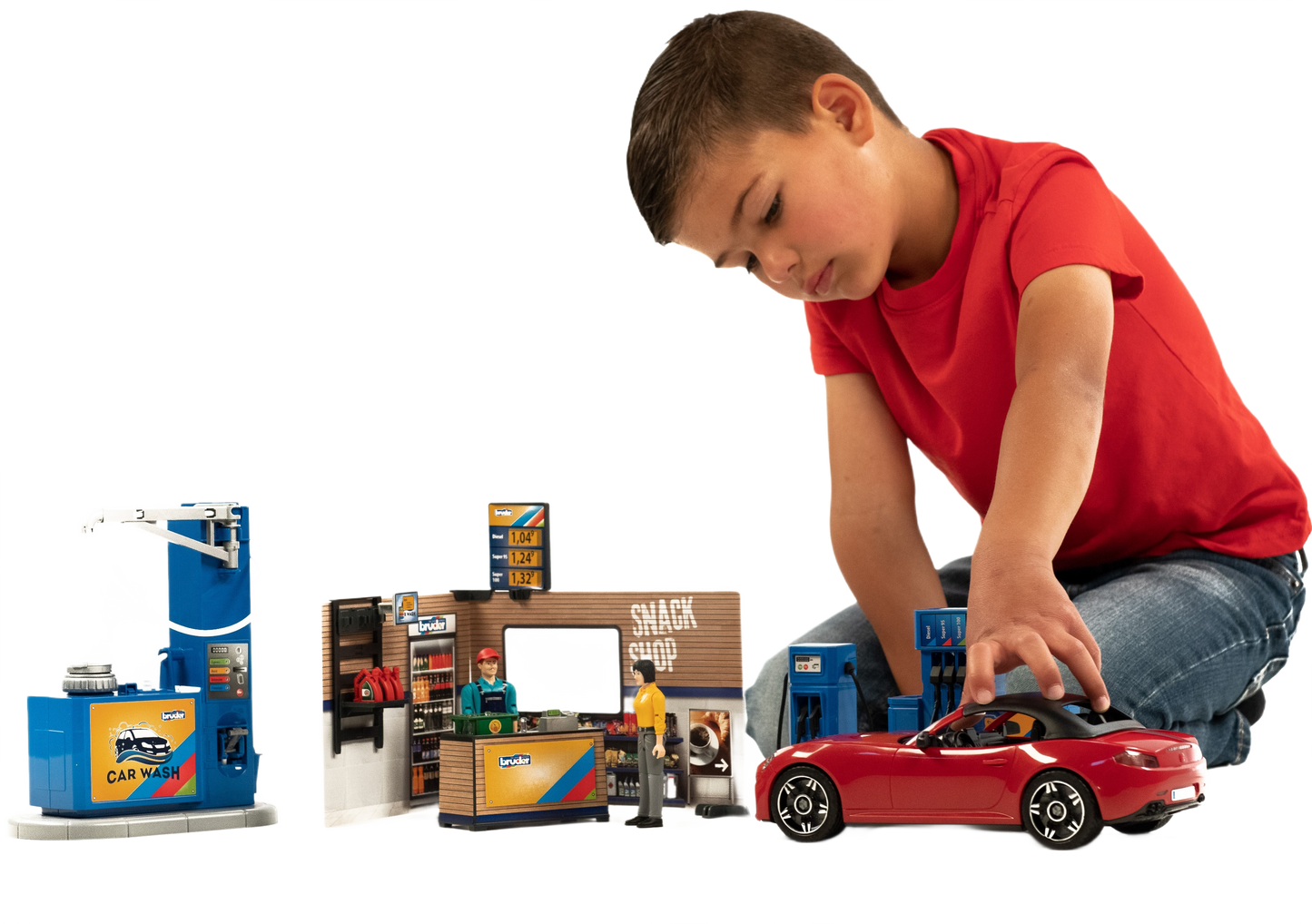 Child playing with Bruder Bworld playset featuring red sports car, gas station, snack shop, and car wash accessories