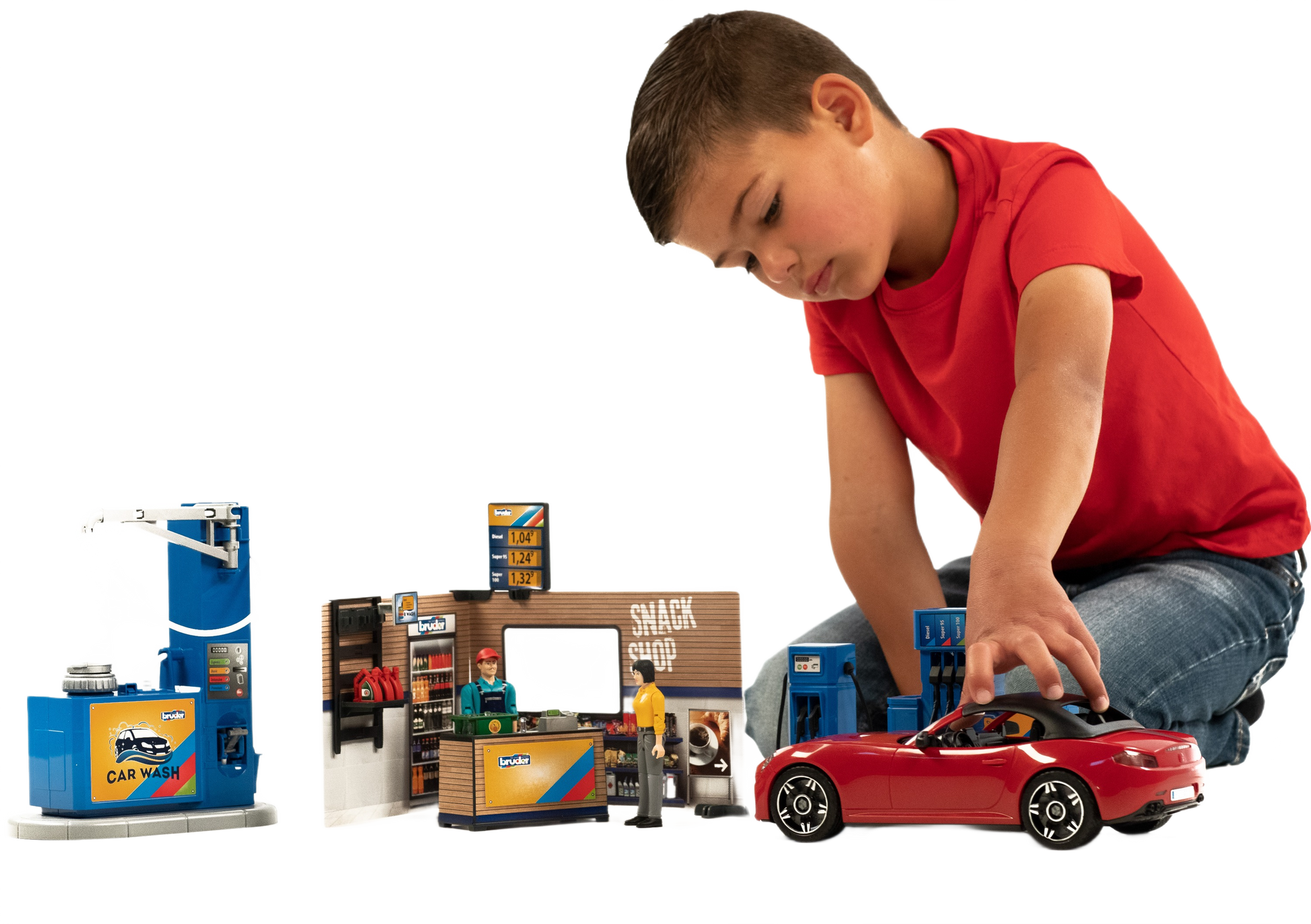 Child playing with Bruder Bworld playset featuring red sports car, gas station, snack shop, and car wash accessories