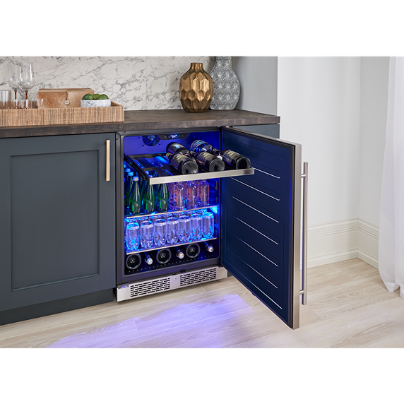 Undercounter beverage center with blue interior lighting, reversible door, and stocked glass bottles in kitchen setting