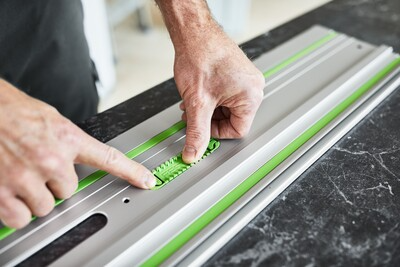 Hands installing green adhesive pads on aluminum guide rail for woodworking tool accessories and home improvement under $50 collections