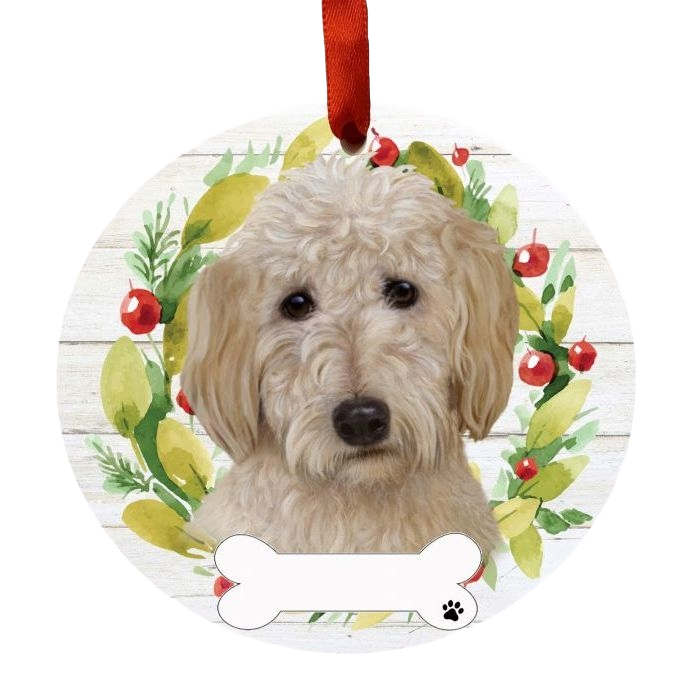 Round Christmas ornament featuring a soft coated Goldendoodle illustration with wreath and red ribbon decoration