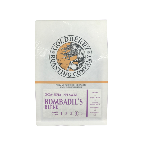 White coffee bag with vintage logo and purple label indicating Bombadil's Blend ground coffee with medium-dark roast level