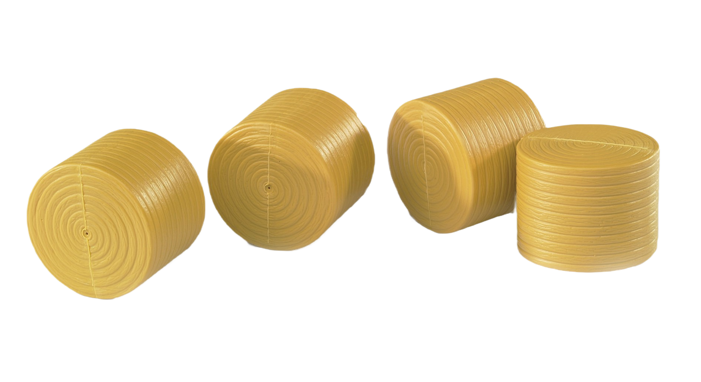 Four yellow plastic round bales designed as detailed miniature accessories for Bruder Claas Rollant 250 models