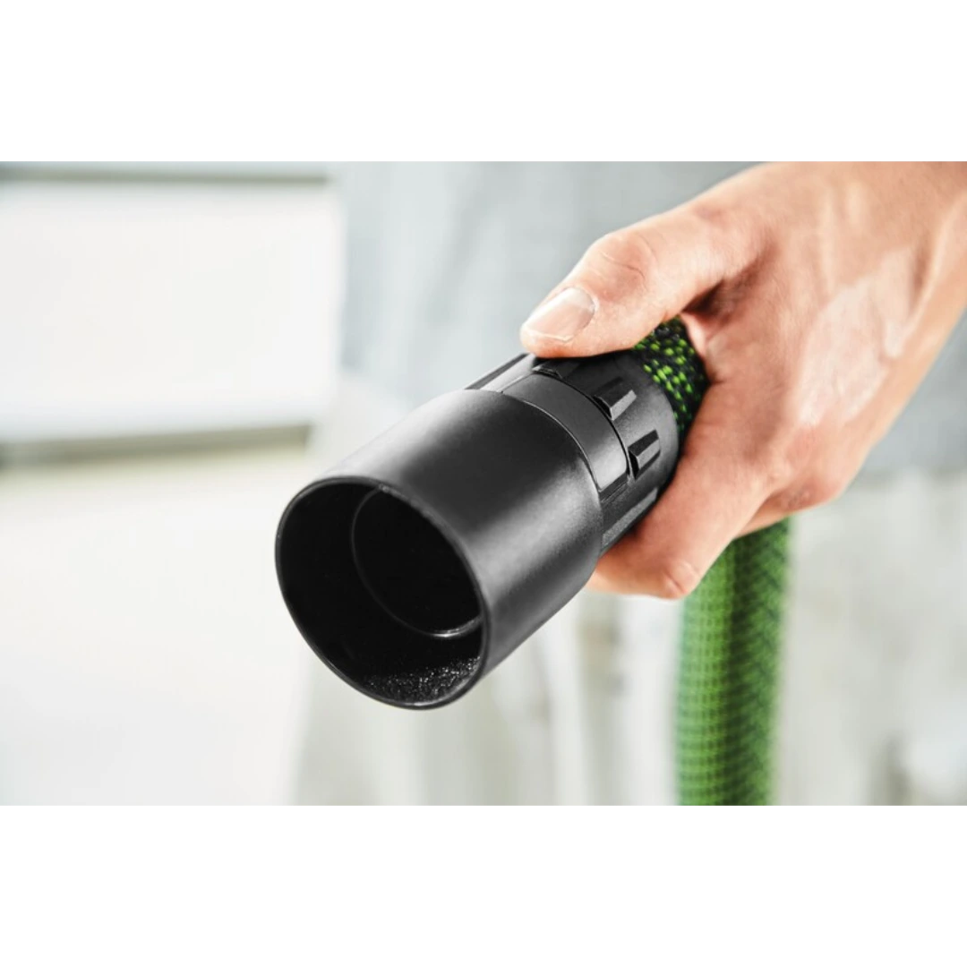 Hand holding black rotating connector sleeve attached to green antistatic hose for dust extractor tools
