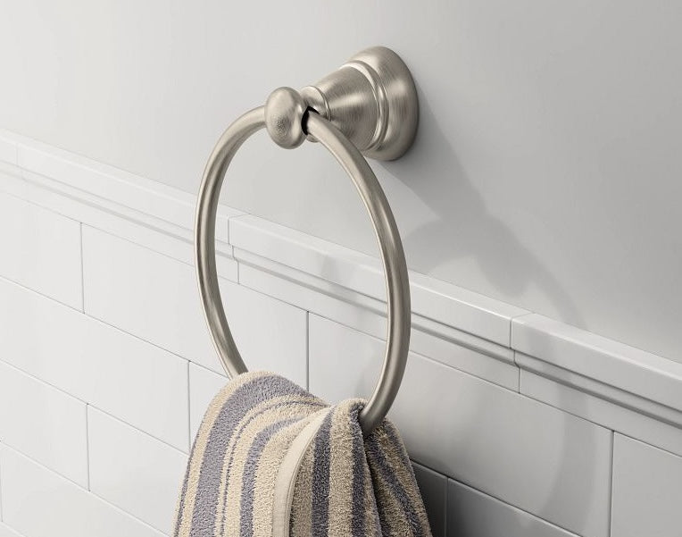 Brushed nickel towel ring mounted on bathroom wall holding a striped towel for home improvement projects