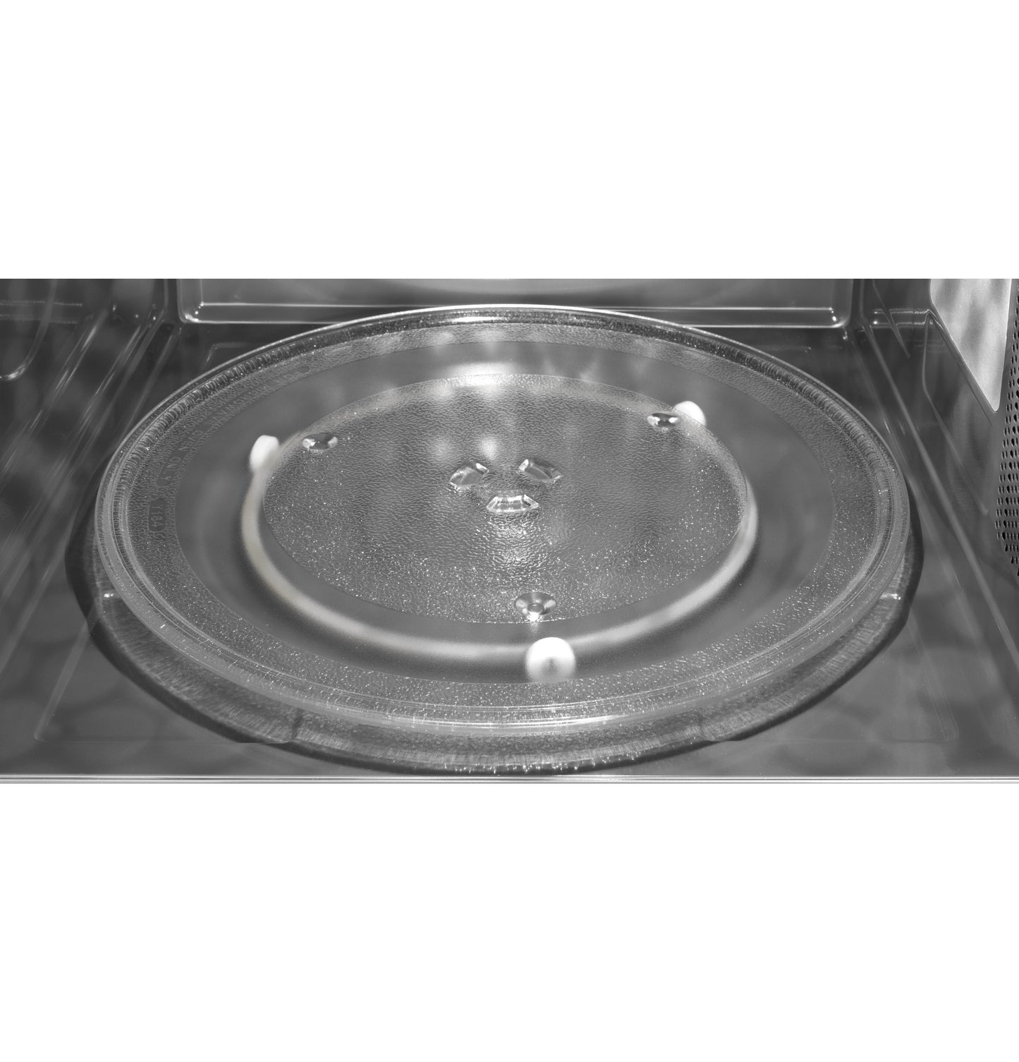 Interior view of glass turntable inside a 24-inch over-the-range microwave from kitchen appliances collection