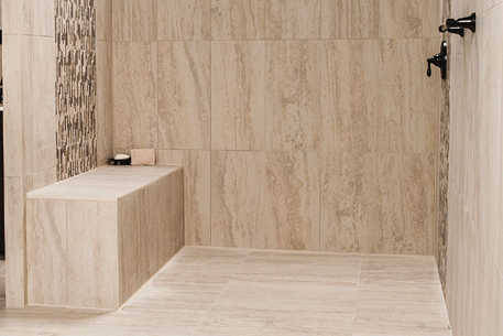 Waterproof rectangular shower bench made with durable KERDI-BOARD integrated in tiled flooring and home improvement space