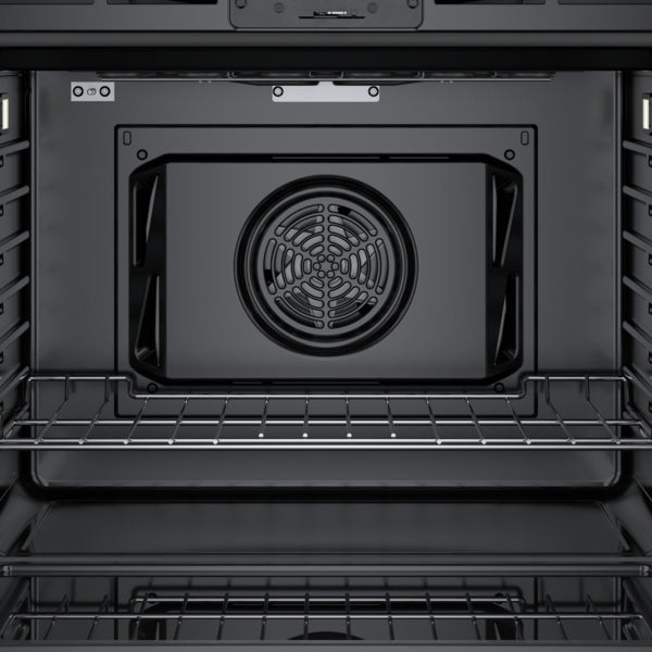 Interior view of a stainless steel wall oven with convection fan and wire rack in Kitchen & Kitchenware at Hartville Hardware