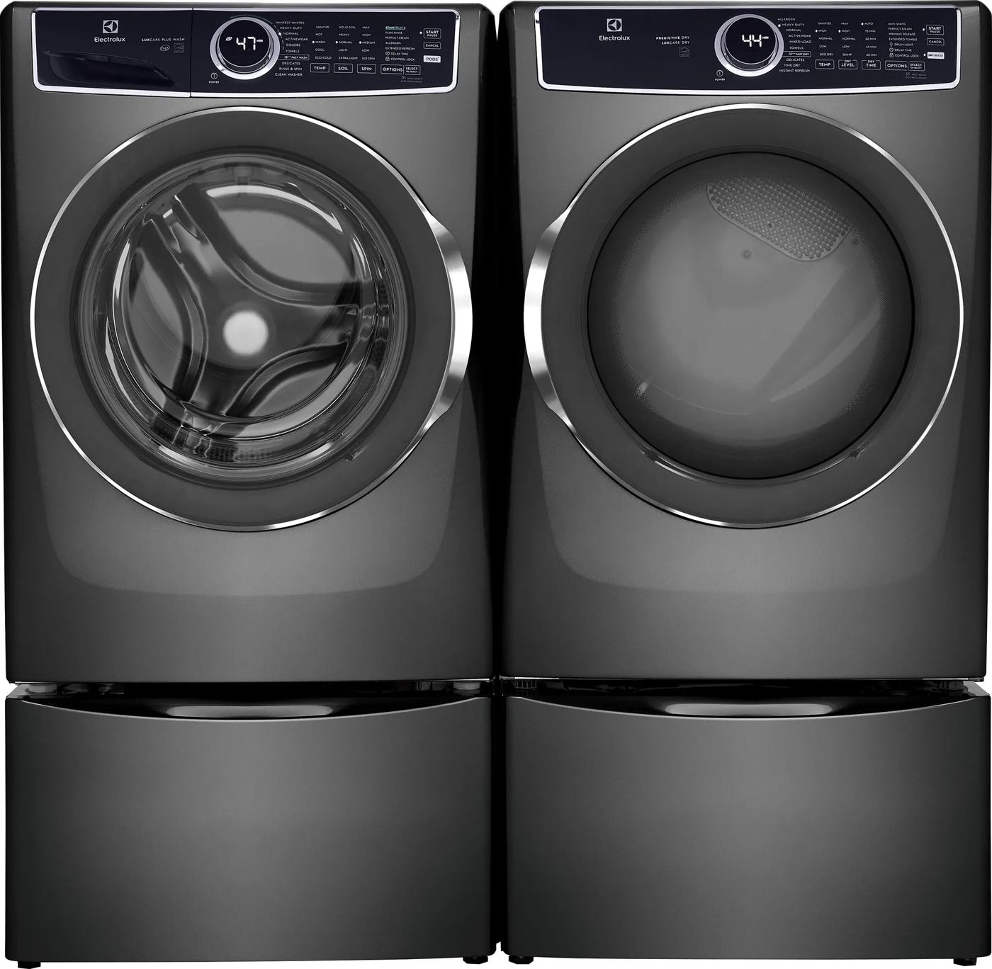 Dark gray front load washer and matching dryer with digital display and pedestal drawers in modern appliances collection