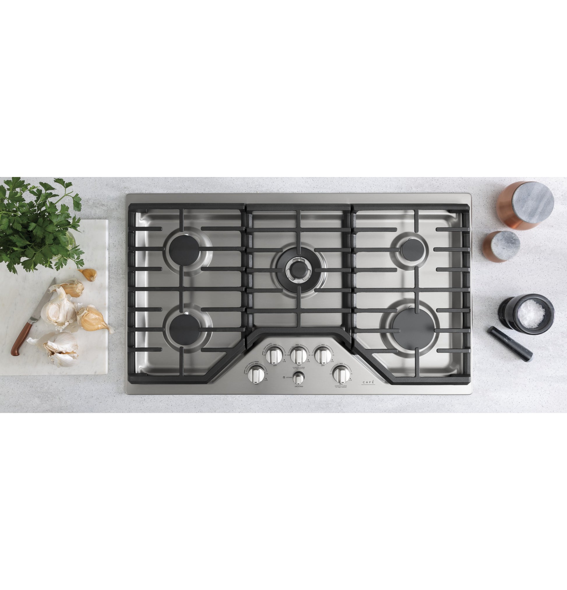 Stainless steel 36-inch gas cooktop with five burners and control knobs in modern kitchen appliances collection