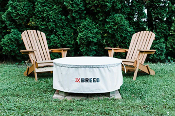 Light gray Breeo fire pit cover with logo, designed for outdoor protection in tools and home improvement settings