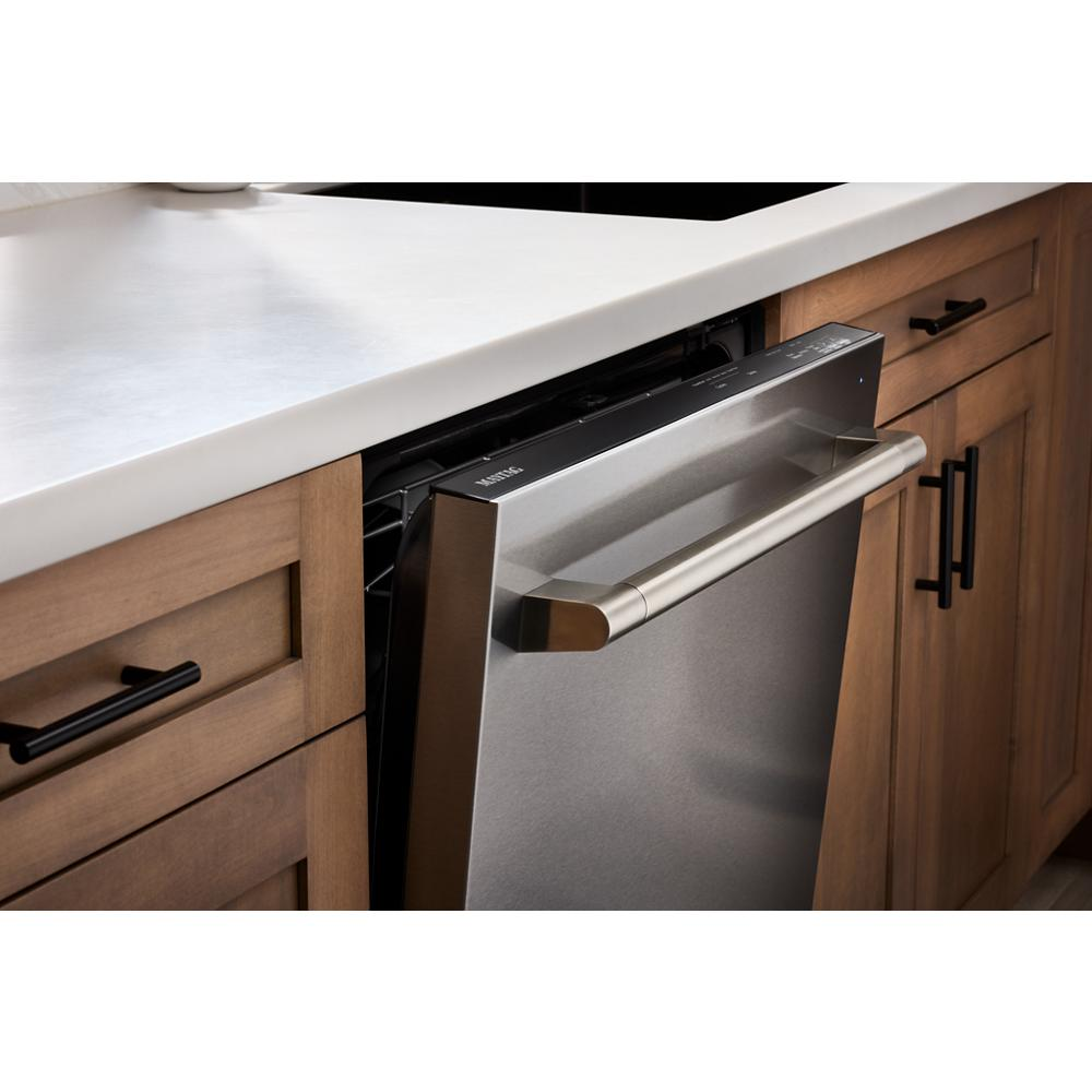 Partially open top control dishwasher in stainless steel built into kitchen cabinetry from appliances collection