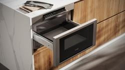 Modern stainless steel drawer microwave integrated into custom kitchen cabinetry in Bosch appliances collection