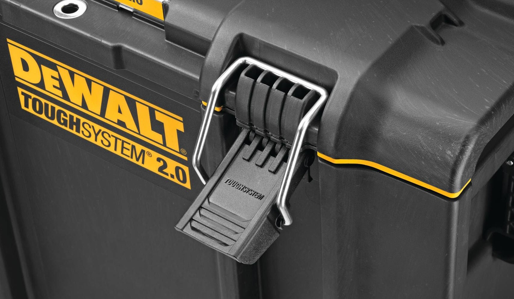 Close-up of durable latch mechanism on black and yellow heavy-duty jobsite storage toolbox for tool organization