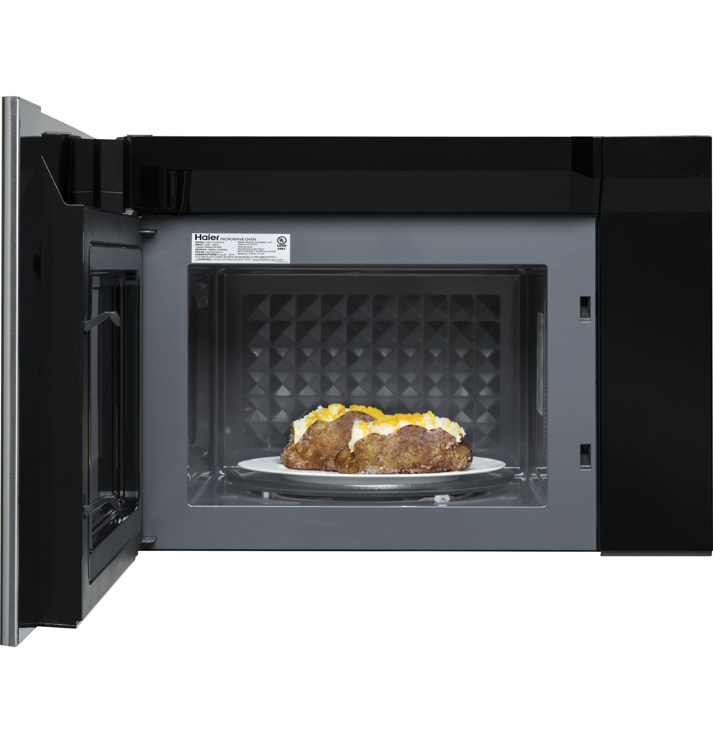 Open door of 24" over-the-range microwave oven showing baked potatoes cooking inside from kitchen appliances collection